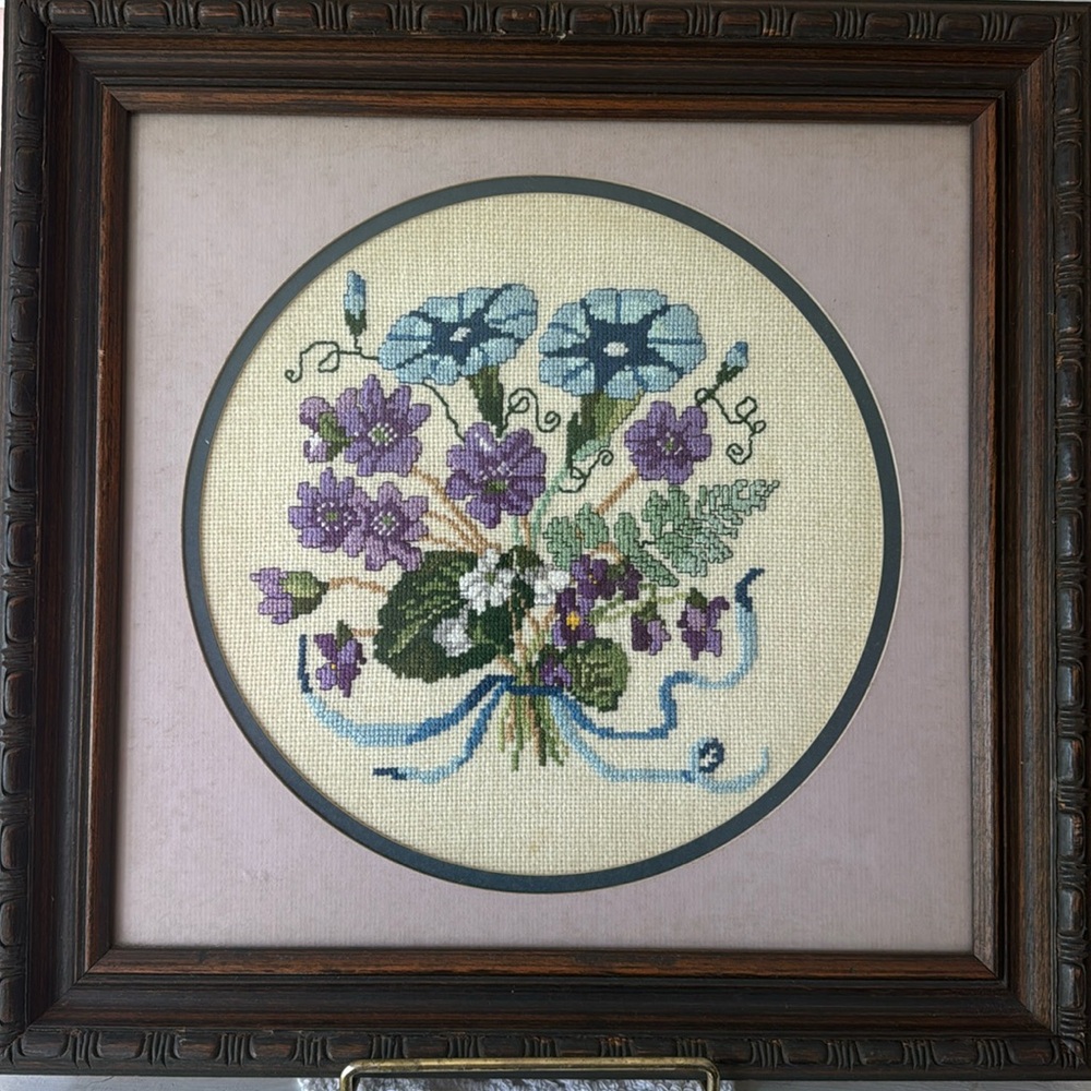 Floral crossstitch framed vintage purples,blues and green flowers .16”X15 & 3/4”